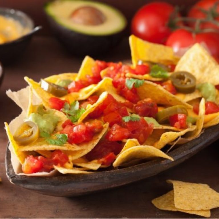 nachos-loaded-with-salsa-guacamole-cheese-and-P7GUFN7-768x460